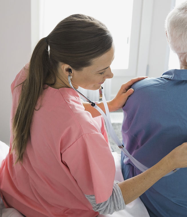 Home Nurse Examining Patient